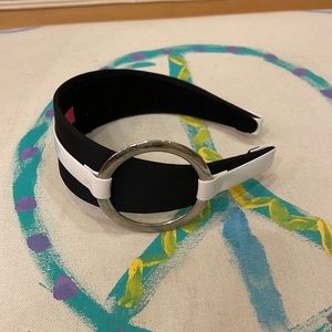 Black headband with white patent stripe and silver circle